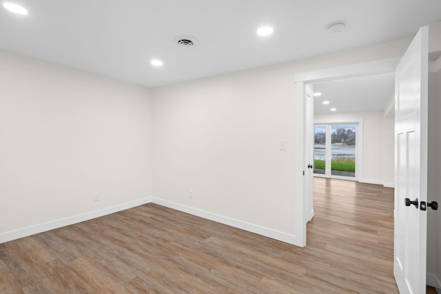 spare room featuring wood-type flooring