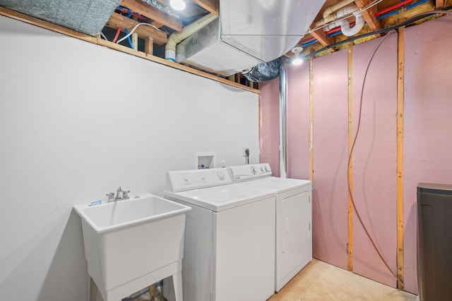 laundry area with washer and clothes dryer and sink