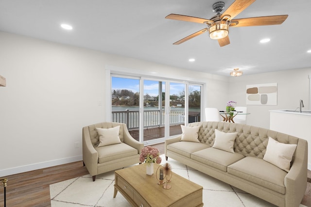 living room featuring light hardwood / wood-style flooring and sink