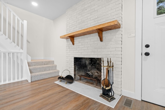 interior details with a fireplace and hardwood / wood-style flooring