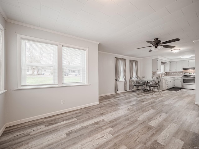 unfurnished living room featuring light wood-type flooring, ceiling fan, and crown molding