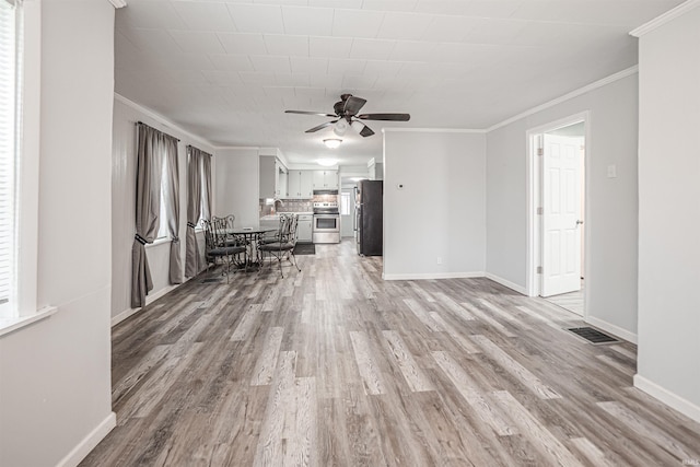 unfurnished living room with crown molding, ceiling fan, and light hardwood / wood-style floors