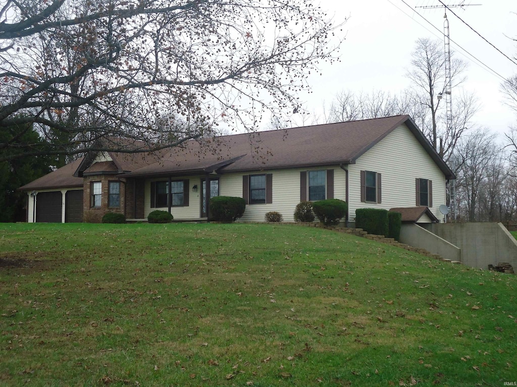 ranch-style home with a front yard and a garage