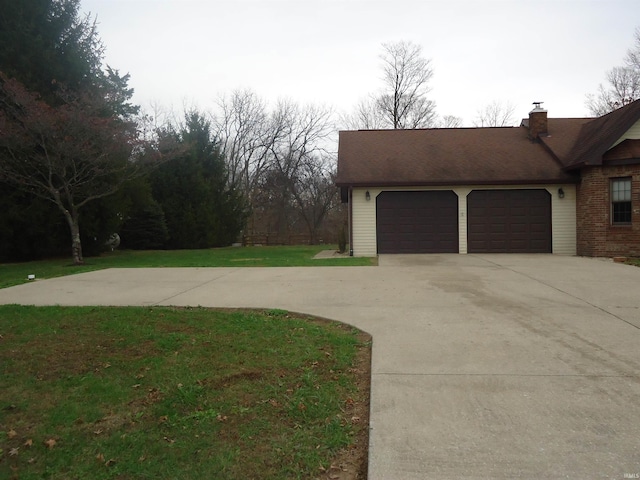 view of home's exterior with a yard and a garage