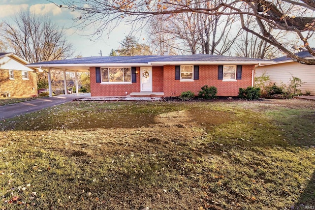 single story home featuring a front lawn and a carport