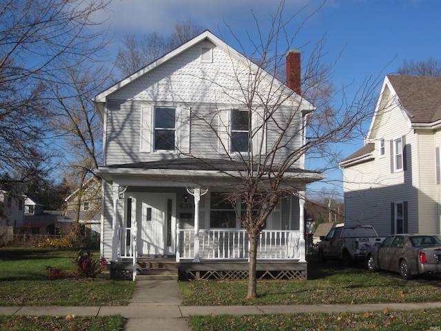 view of front property with a porch and a front yard