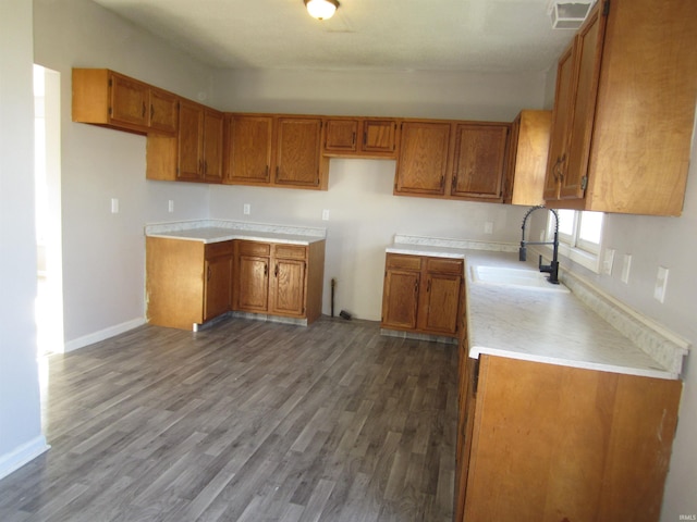 1314 S Boots St, Marion, IN 46953 - kitchen with brown cabinetry, wood finished floors, and light countertops