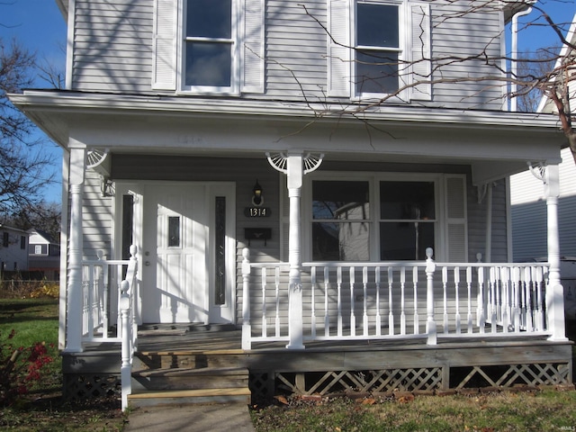 entrance to property featuring a porch