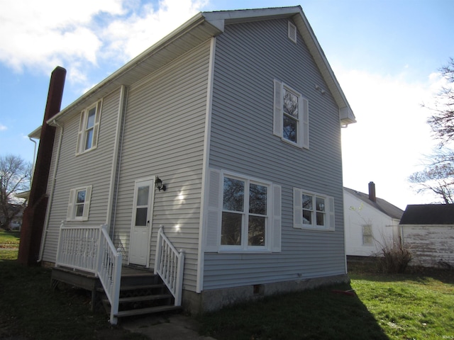 back of house with a yard