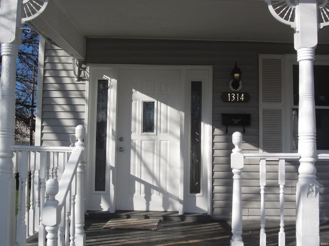 entrance to property featuring a porch