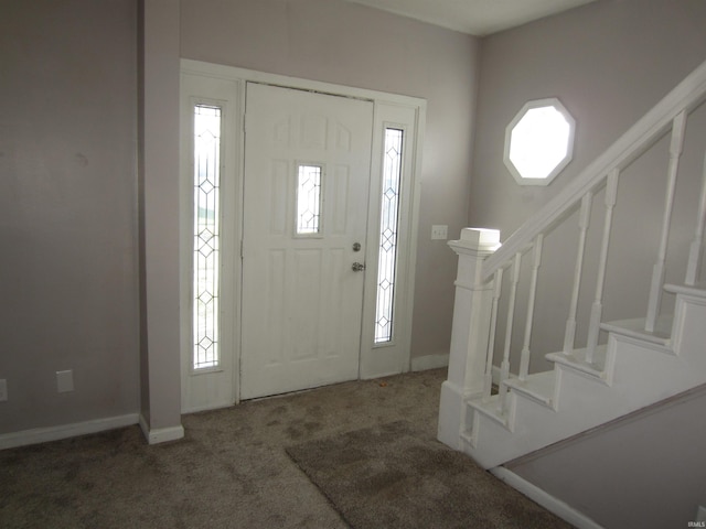 view of carpeted foyer entrance