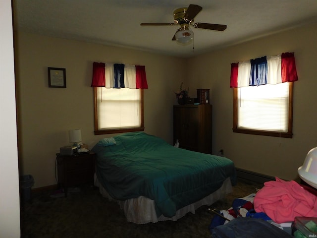 bedroom with a baseboard radiator, ceiling fan, and baseboards