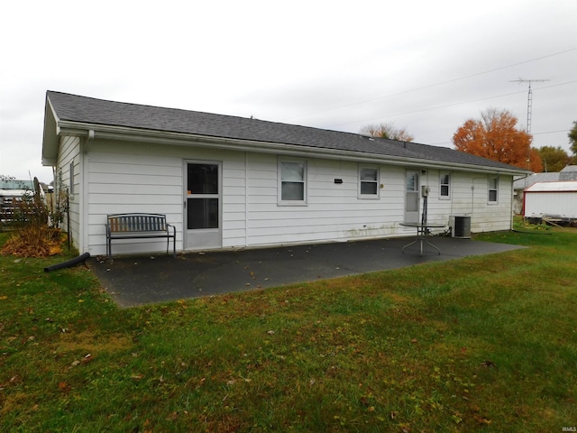 back of property featuring central AC, a yard, and a patio area