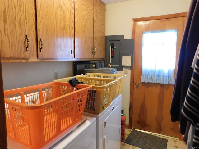 clothes washing area with washing machine and dryer, electric panel, and cabinet space