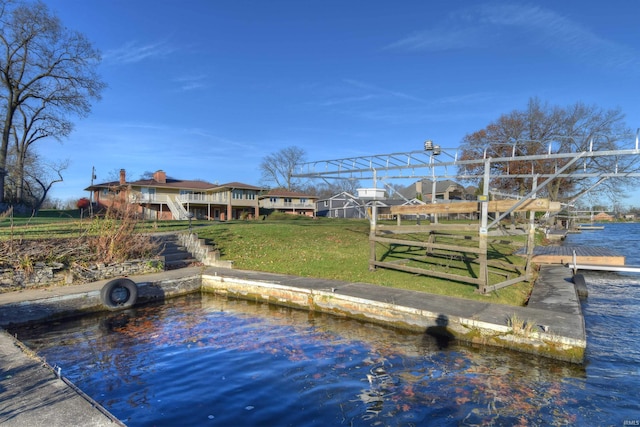 view of dock featuring a yard and a water view