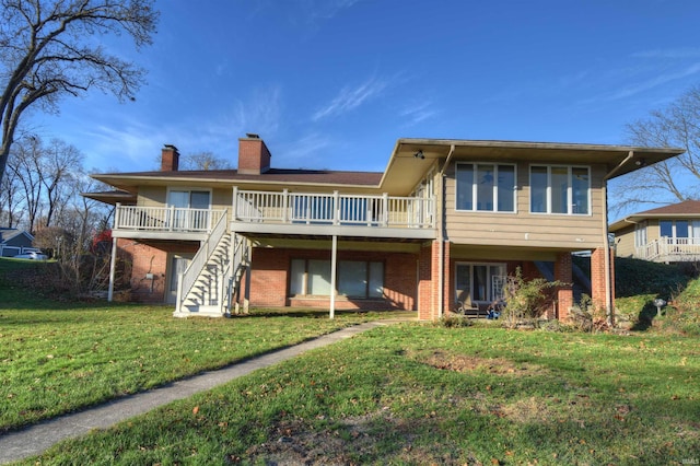 back of house featuring a wooden deck and a yard