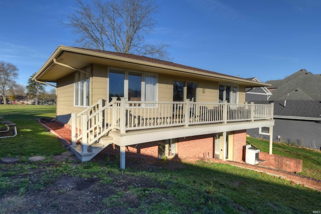 back of house with a lawn and central AC unit