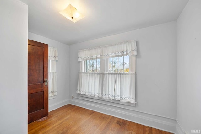 empty room with hardwood / wood-style floors