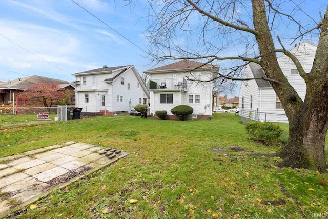 rear view of property featuring a lawn