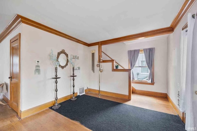 interior space with light hardwood / wood-style floors and crown molding