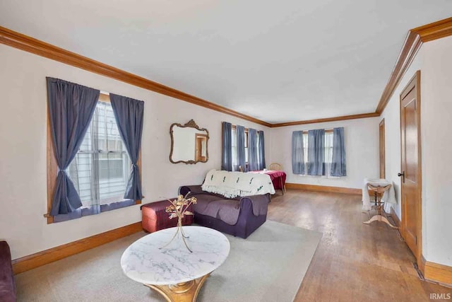 living room featuring crown molding, plenty of natural light, and wood-type flooring