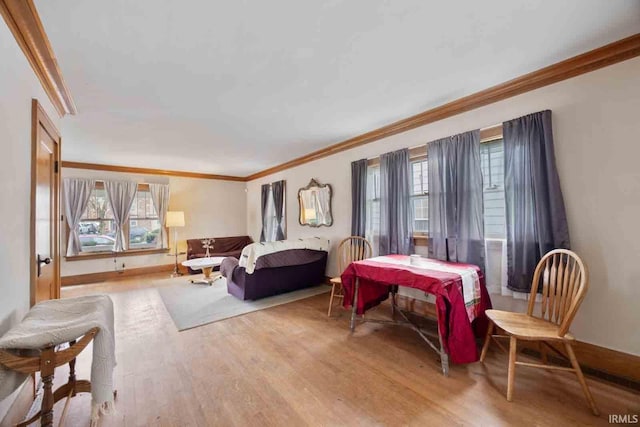 interior space with light wood-type flooring and ornamental molding