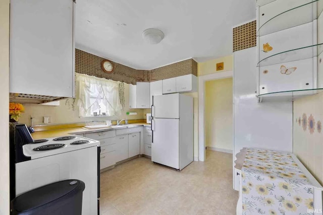 kitchen featuring white cabinets, white appliances, and sink