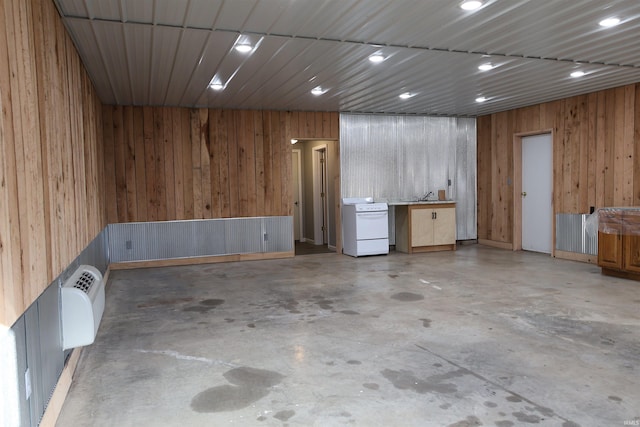 basement with wood walls and a wall unit AC