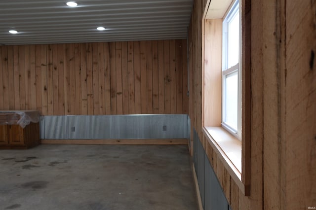 spare room featuring wood walls