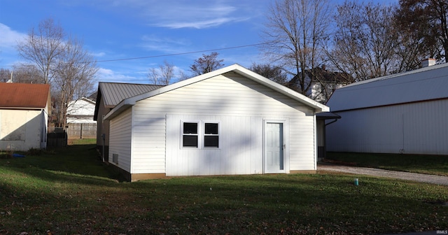 view of outbuilding with a yard