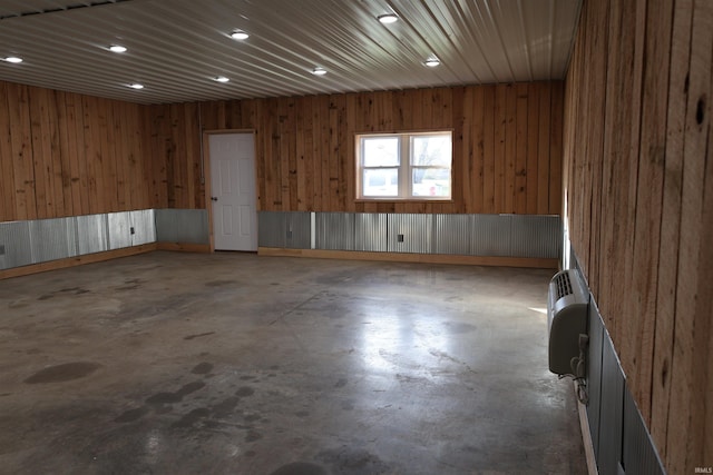 empty room featuring wood walls