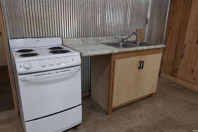 kitchen featuring light brown cabinetry, electric range, sink, and wooden walls