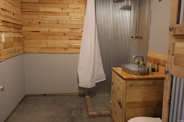 bathroom featuring concrete floors, toilet, and sink