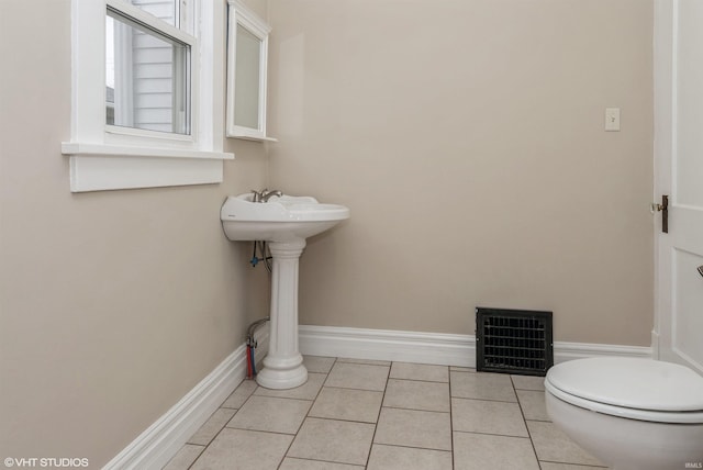 bathroom featuring tile patterned floors, toilet, and sink