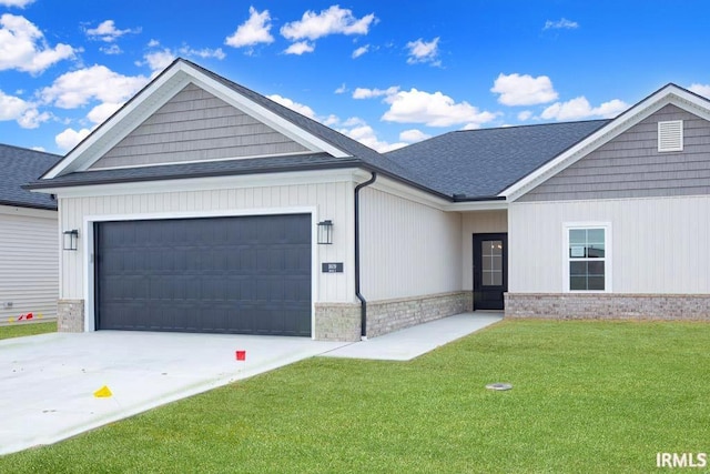 view of front of house with a garage and a front lawn