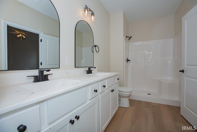 1609 Theo Dr Unit 2, Evansville, IN 47711 - bathroom featuring a shower, hardwood / wood-style floors, vanity, and toilet
