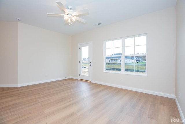 spare room featuring light wood-type flooring and ceiling fan