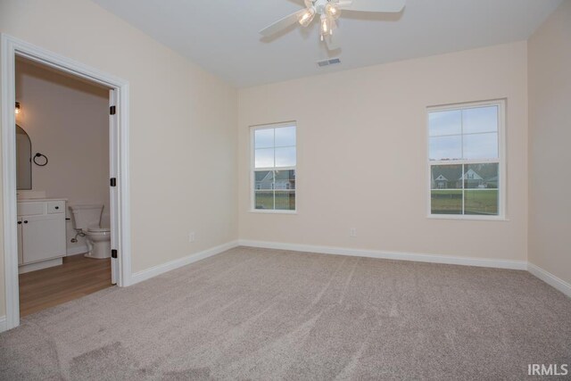 1609 Theo Dr Unit 2, Evansville, IN 47711 - unfurnished bedroom featuring ceiling fan, light colored carpet, and ensuite bathroom