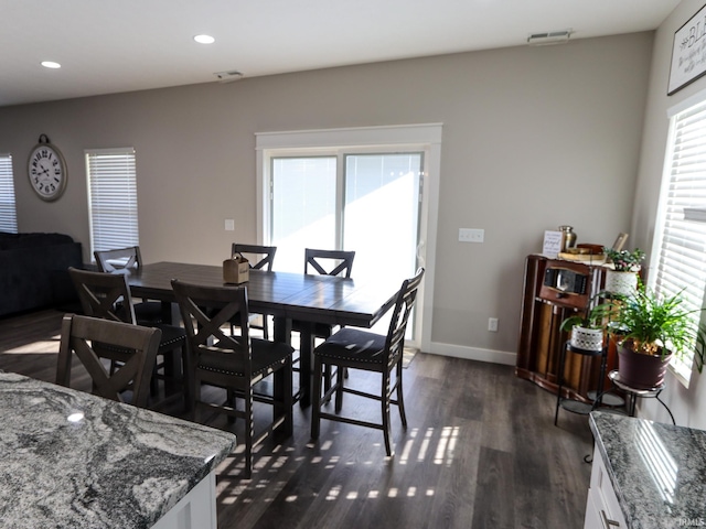 dining space with dark wood-type flooring