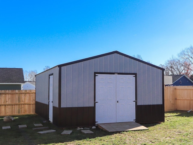 view of outbuilding with a yard