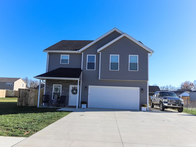 view of property featuring a front yard and a garage