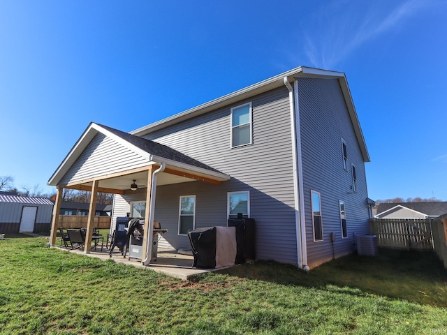 back of property with a patio area, ceiling fan, a yard, and central AC unit