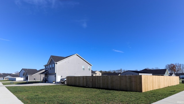 view of home's exterior featuring a yard and a garage