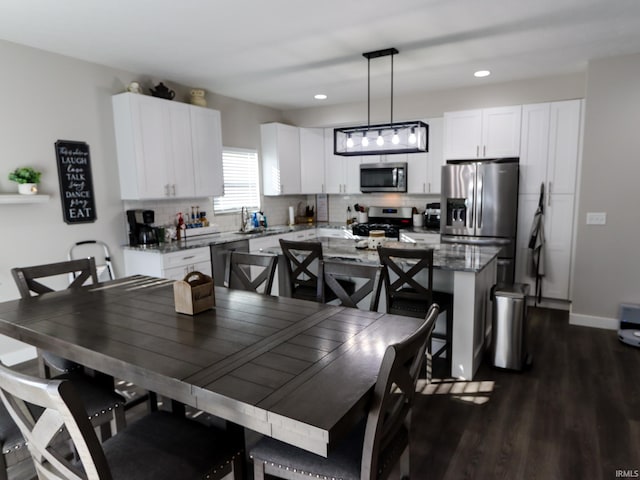 dining room with sink and dark wood-type flooring