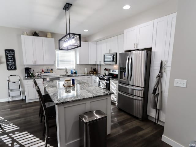 kitchen with white cabinets, appliances with stainless steel finishes, and a kitchen island