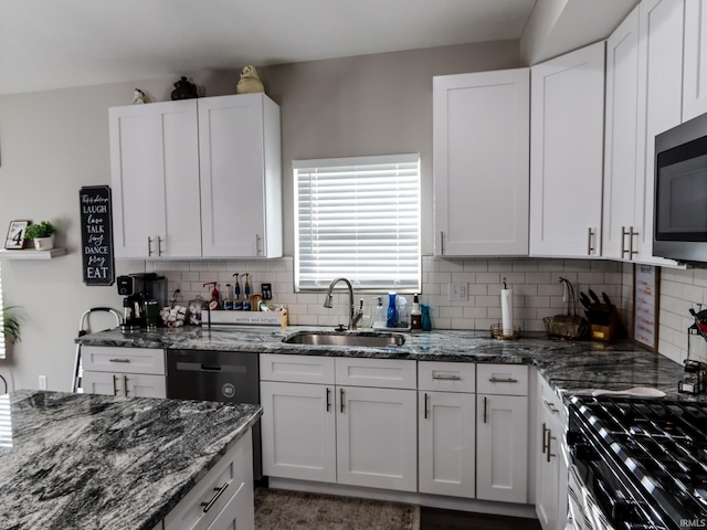 kitchen with backsplash, white cabinetry, sink, and stainless steel appliances