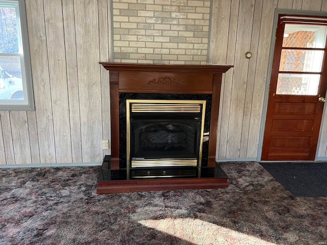 interior details with carpet flooring and wooden walls