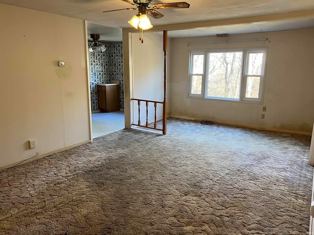 carpeted spare room featuring ceiling fan