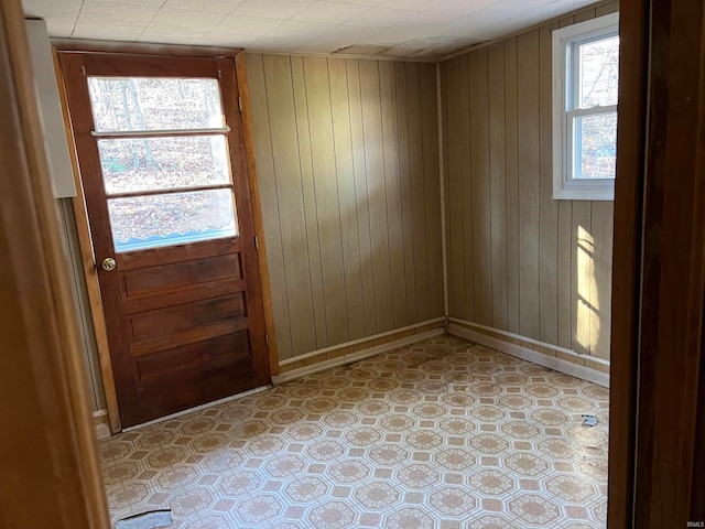 doorway featuring wooden walls