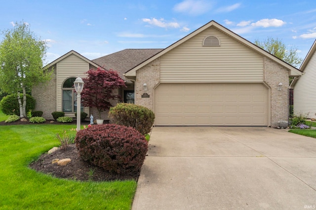 view of front of home featuring a garage and a front lawn